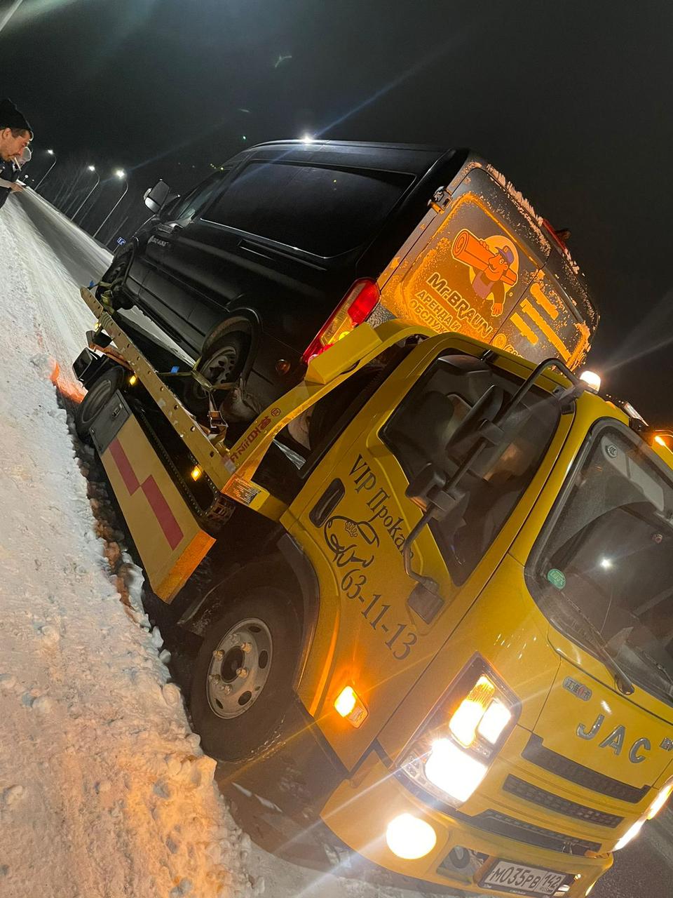 Водитель эвакуатора готовится к выезду на вызов, обеспечивая быструю помощь